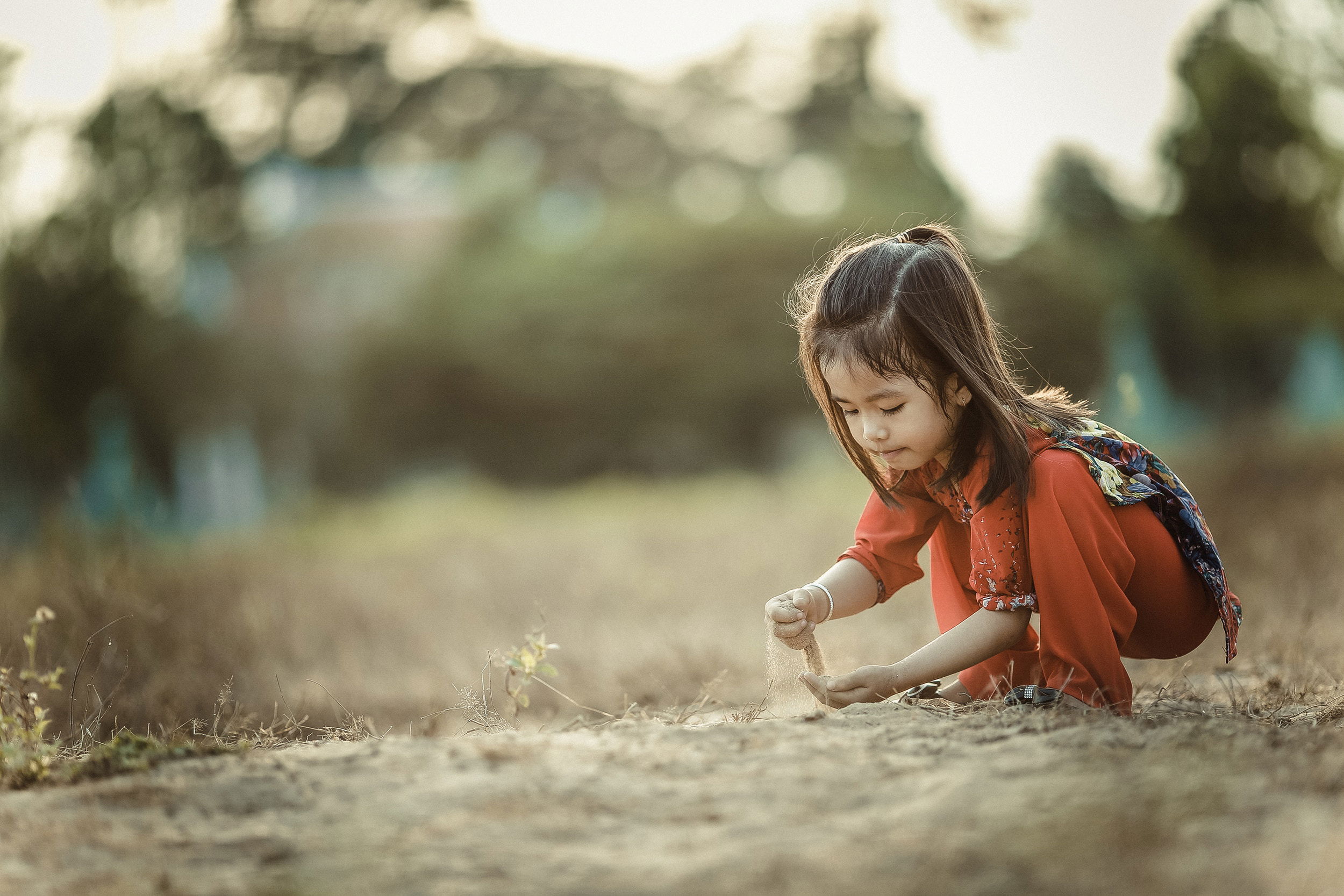 Chlidern playing with sand