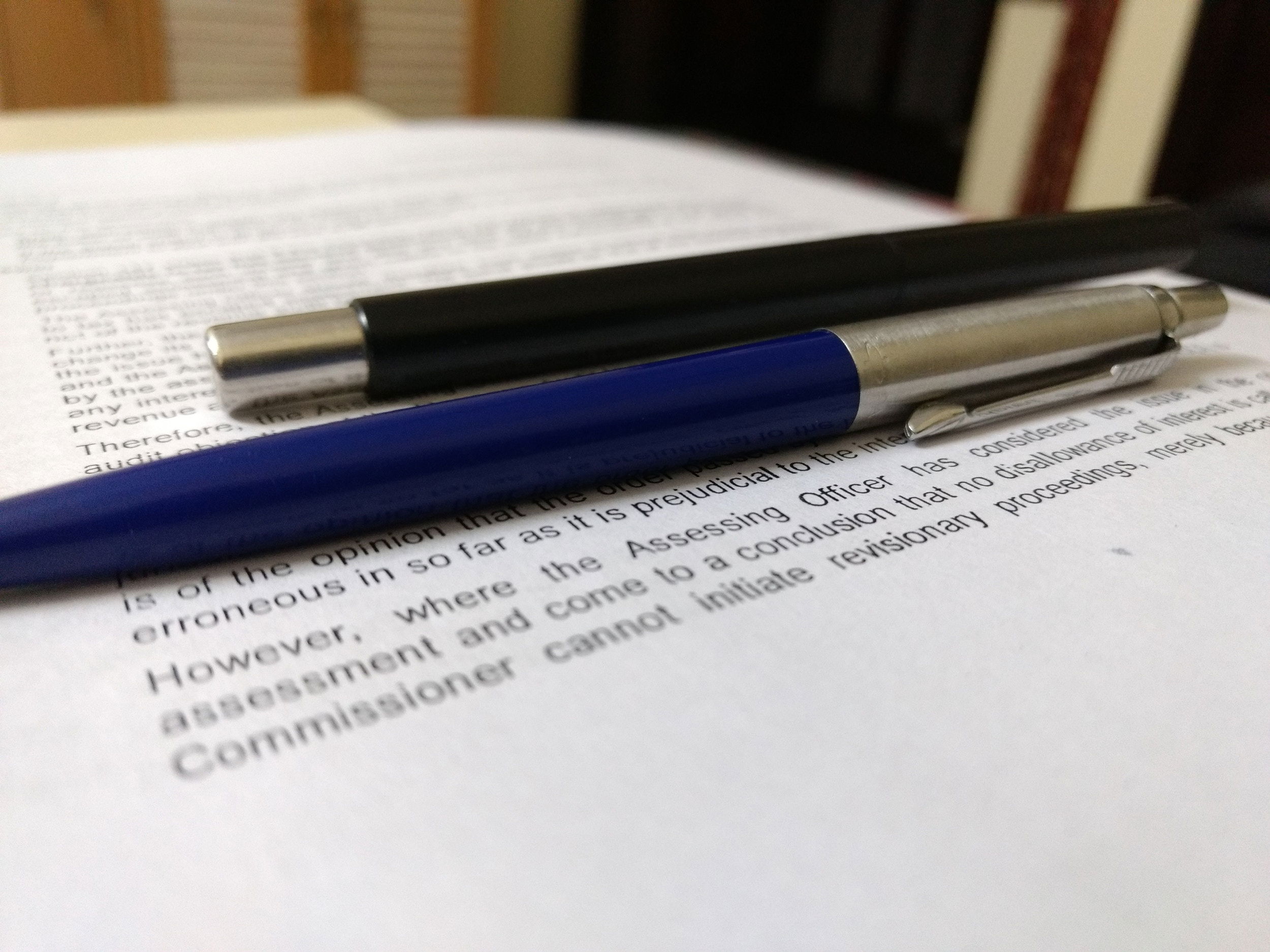 folder labelled Compliance and Policies on desk with pen