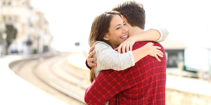 Couple Hugging Happy In A Train Station