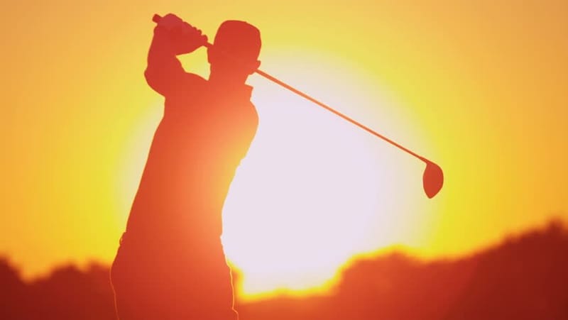 Playing golf during the Summer season.