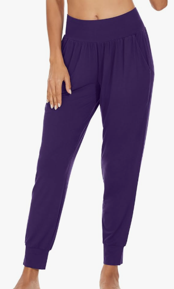 A woman wearing comfortable and lightweight bamboo joggers in a beautiful purple with pockets