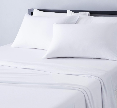 White sheets and pillows are shown on a nicely made bed.