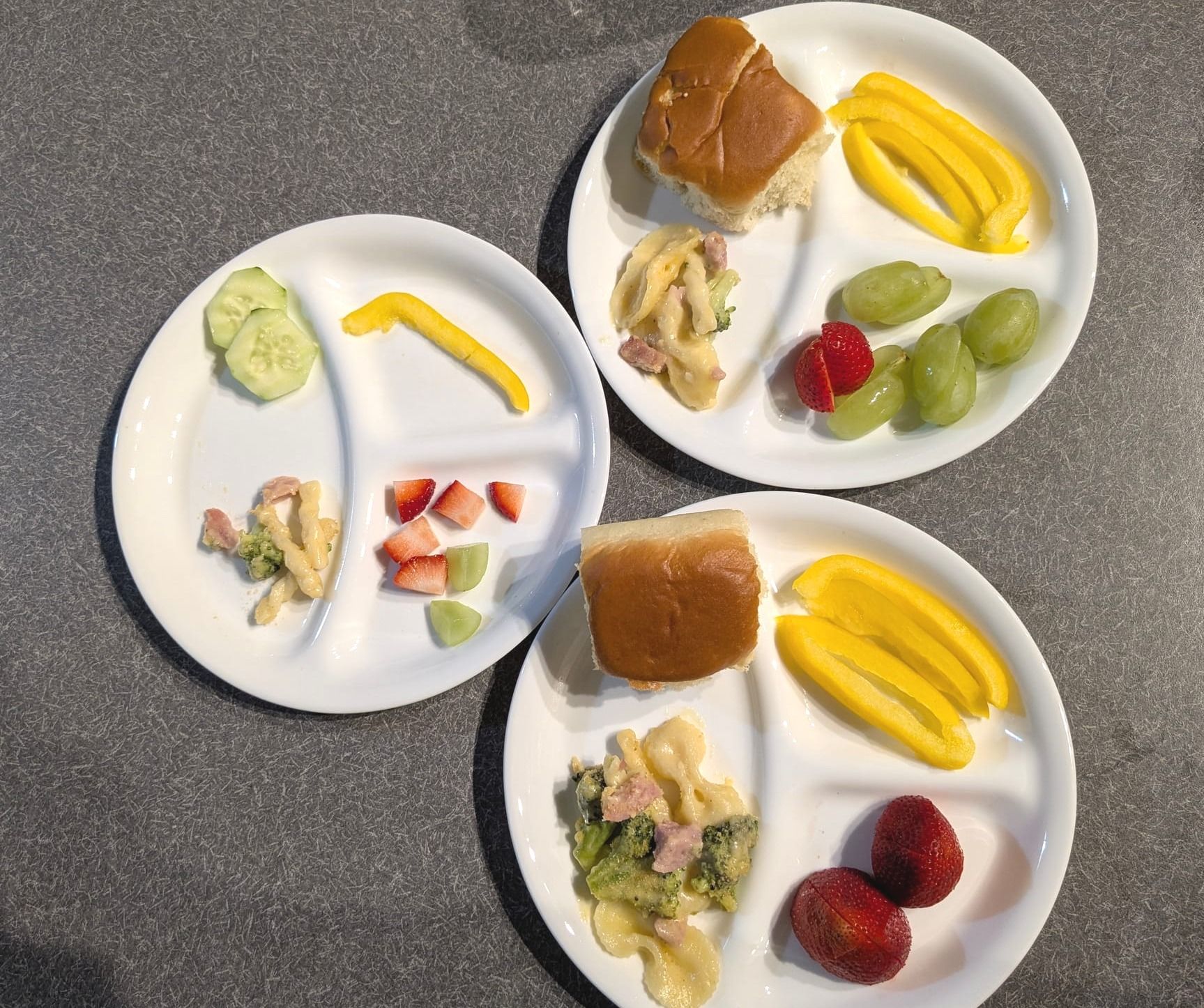Four white divided glass plates