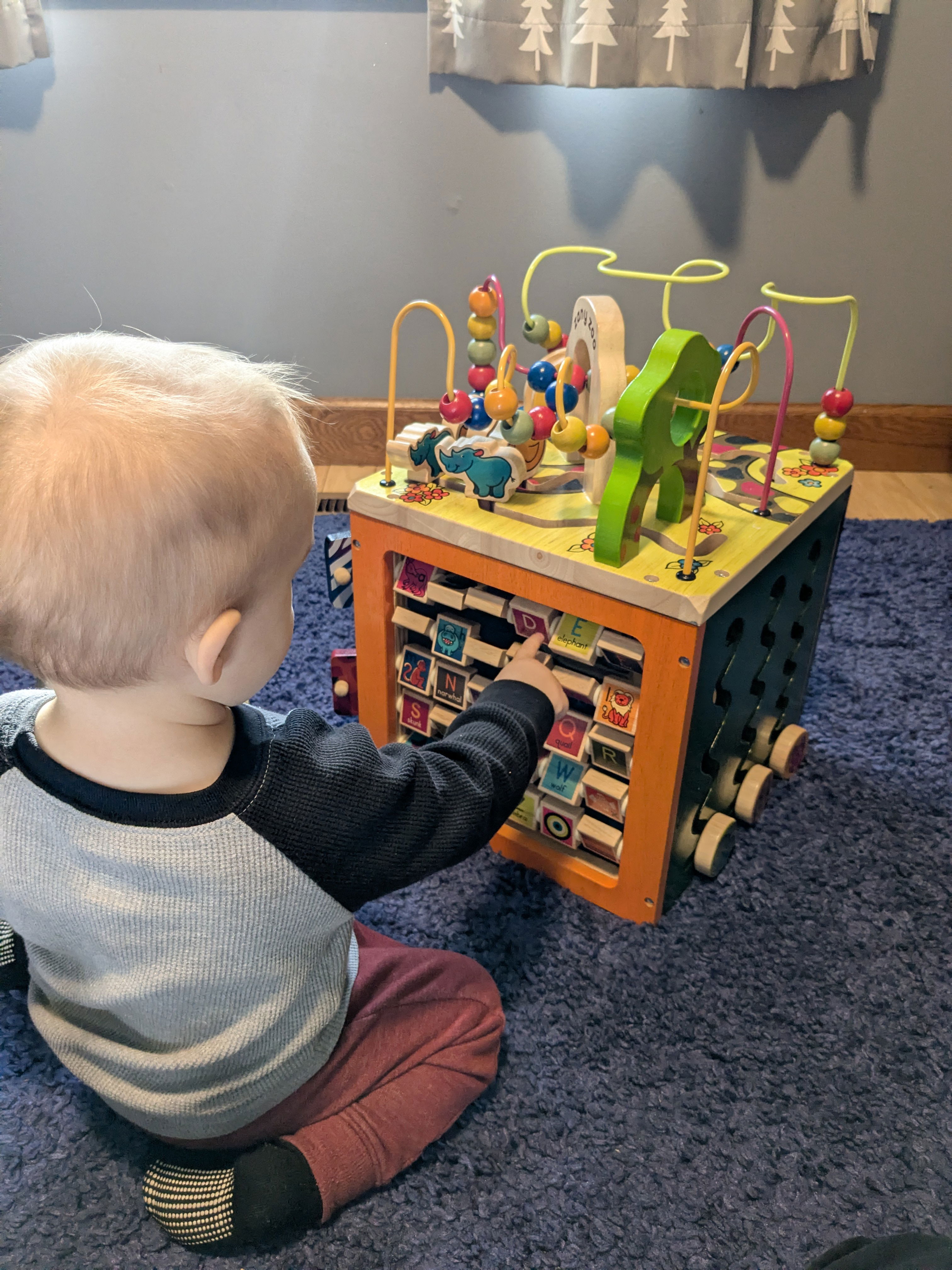A toddler playing with an activity center