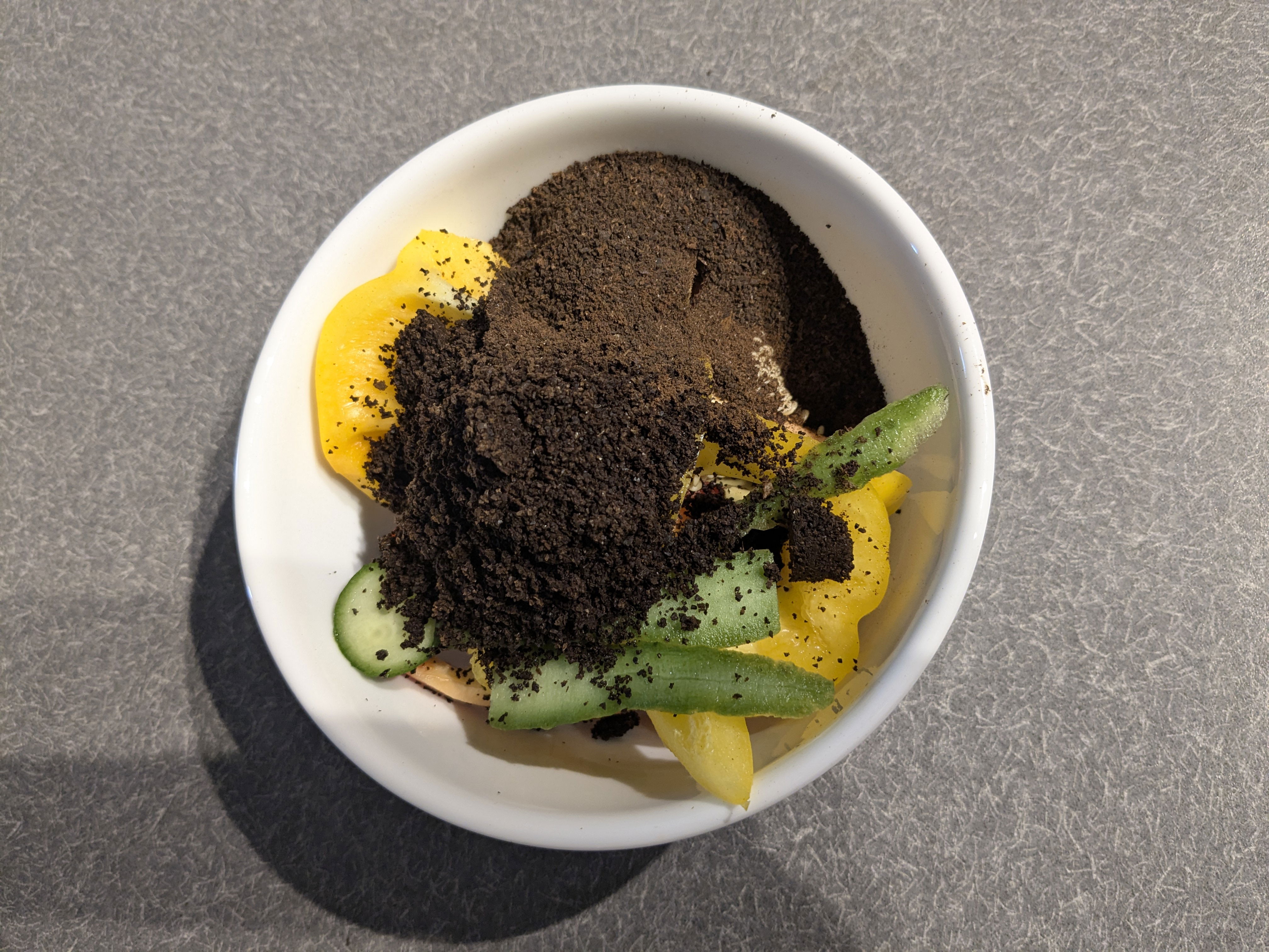 Compost ready to go out including pepper and cucumber scraps along with coffee grounds