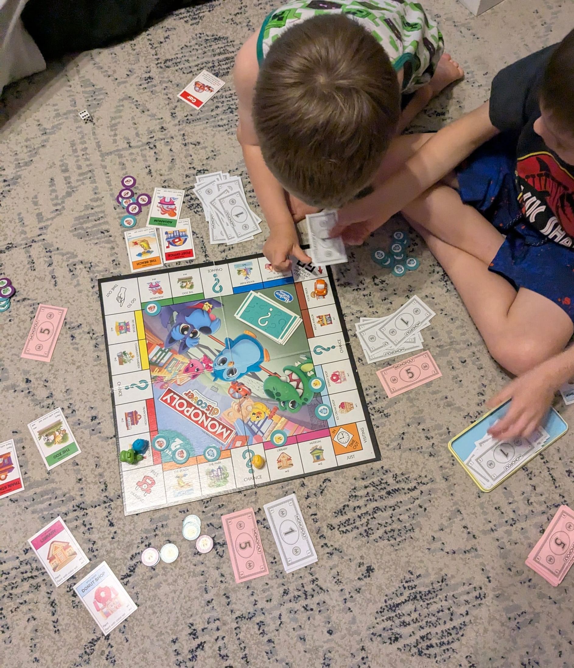 Two young boys playing Monopoly 