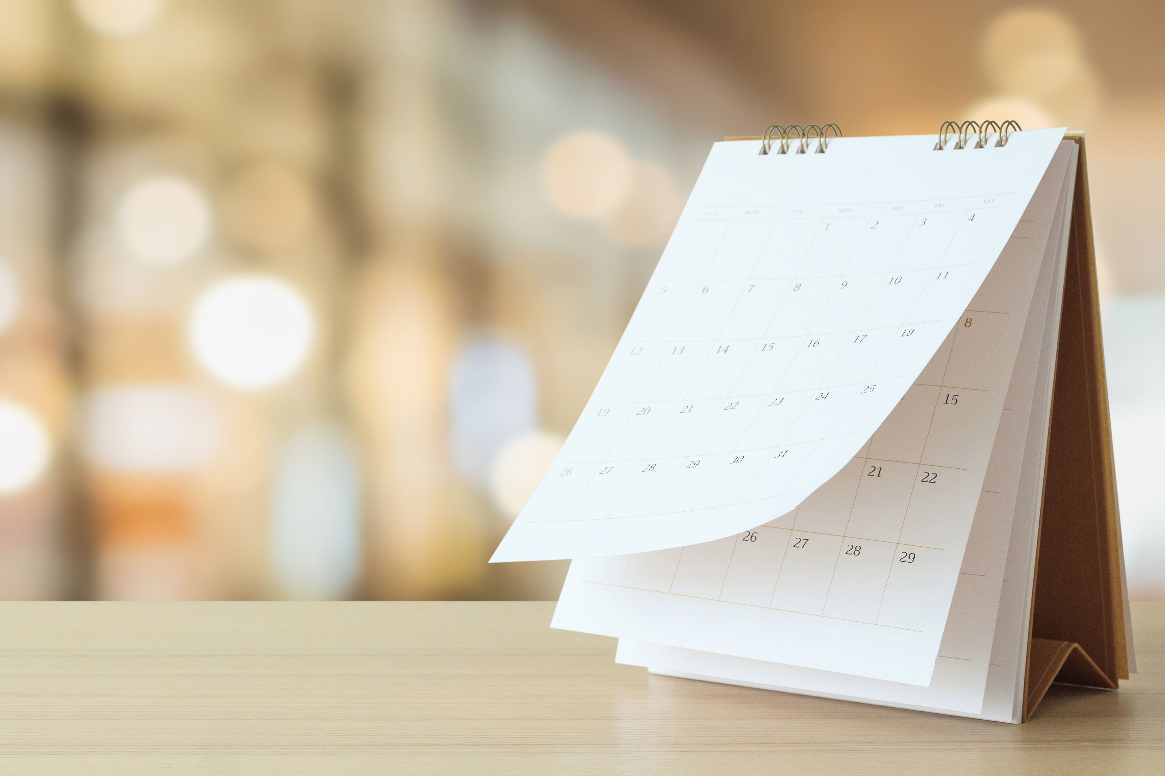 A flip calendar is shown with a bright and cheery background.