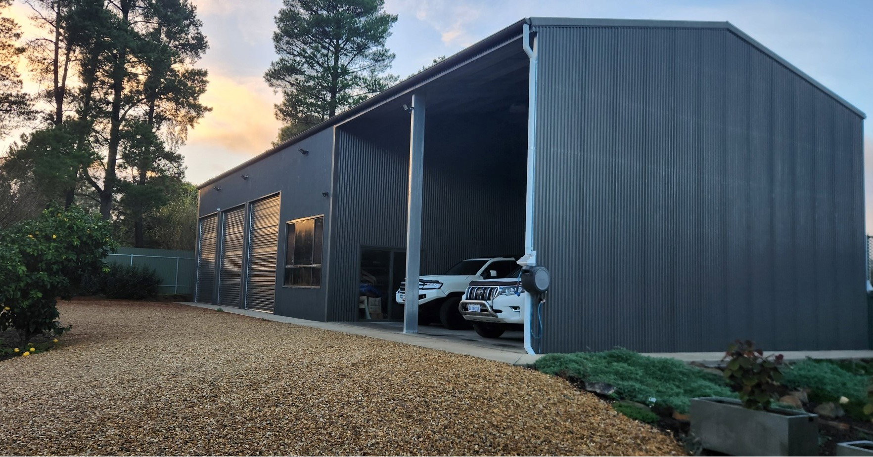 A modern building with cars parked in the garage, featuring high-quality carports Adelaide for protection and style.