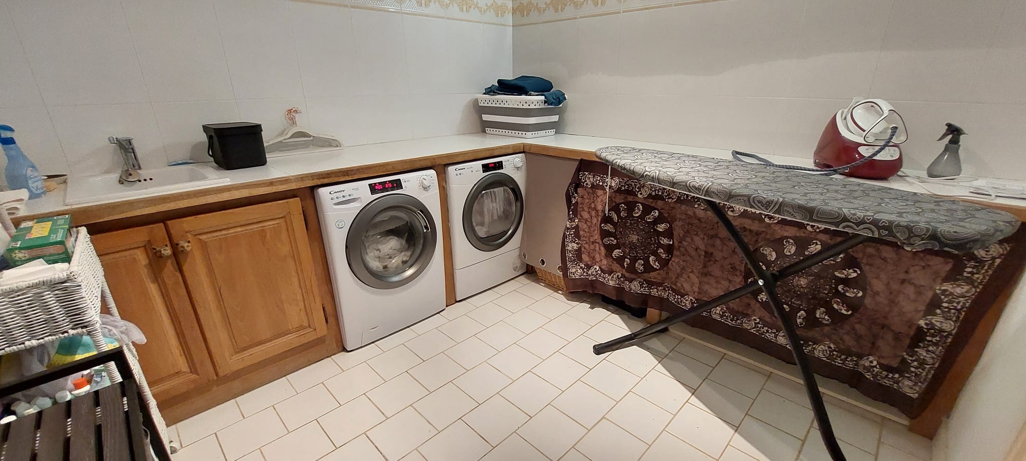 Grande buanderie équipée lave linge et sèche linge, centrale et table
