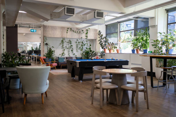  An expansive office area with a pool table and seating, promoting social interaction in a coliving space.