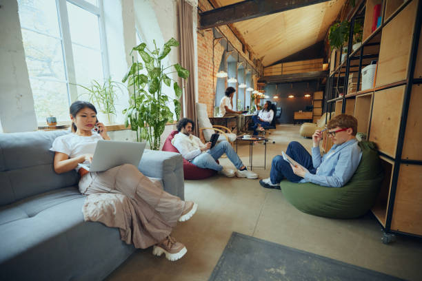 People gathered on bean bags in an office setting, representing a vibrant and social co-living space experience.