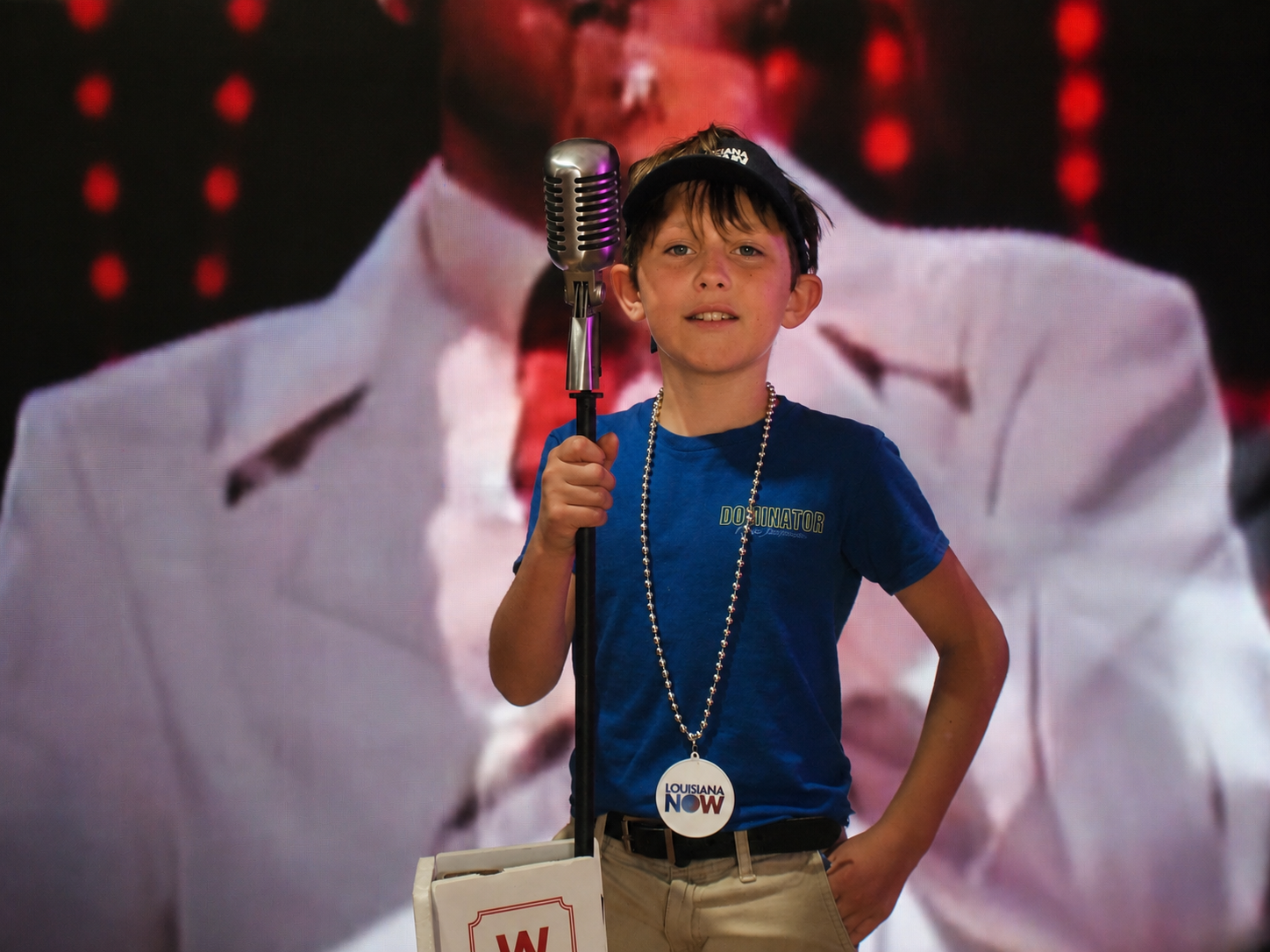 Freedom 250 event: a boy expresses his inner Elvis before a mock WSM microphone and video board at the Tennessee booth, The Great American State Fair, National Mall, Washington, DC, July 8, 2026 [Photo: S Cobaugh]