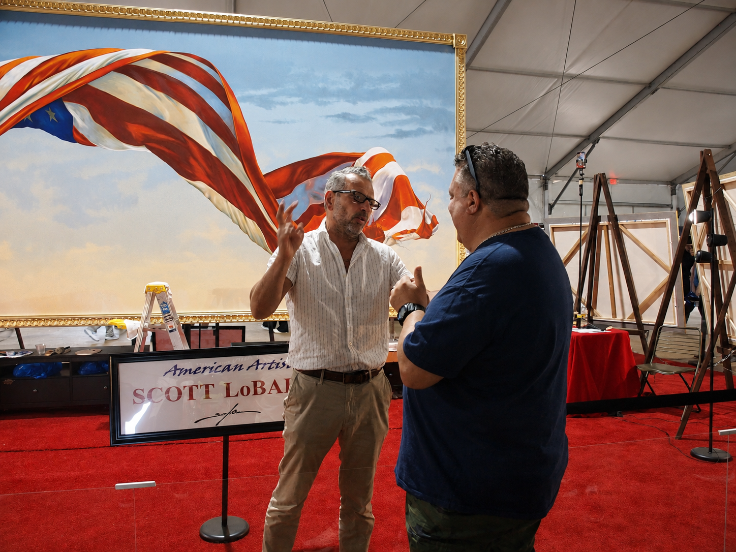 Freedom 250 event: Staten Island, NY, artist Scott LoBaido (left) speaks to a fairgoer in front of a 9-by-17-foot painting being done live in the Made in America pavilion, The Great American State Fair, National Mall, Washington, DC, July 8, 2026 [Photo: S Cobaugh]