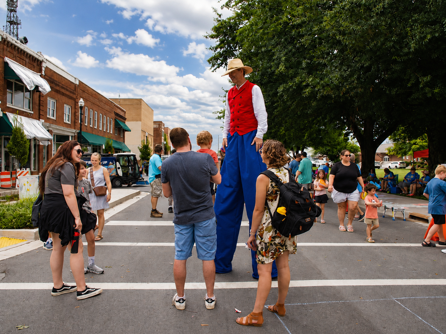 Kingsport Fun Fest: A man wearing stilts captures the attention of bystanders during the Downtown Street Fair, July 18, 2026 [Photo: J Lowry]