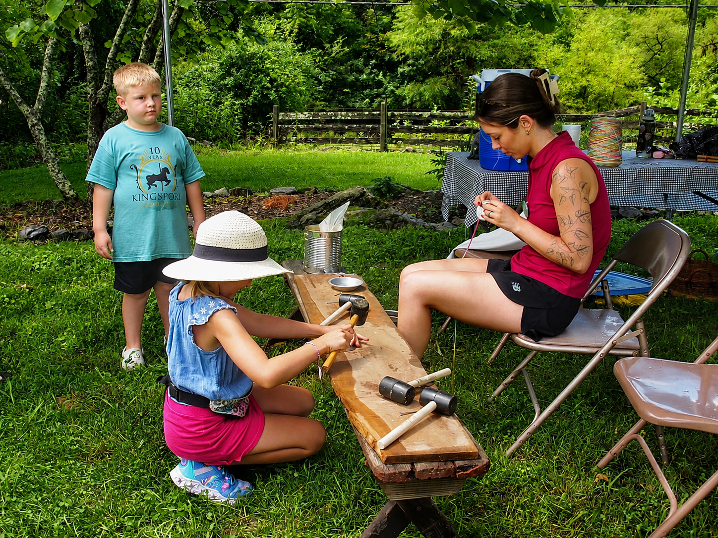 Kingsport Fun Fest: A girl creates a handmade necklace during the Farm Fest at Exchange Place Living History Farm, Kingsport, TN, July 19, 2026 [Photo: S Cobaugh]