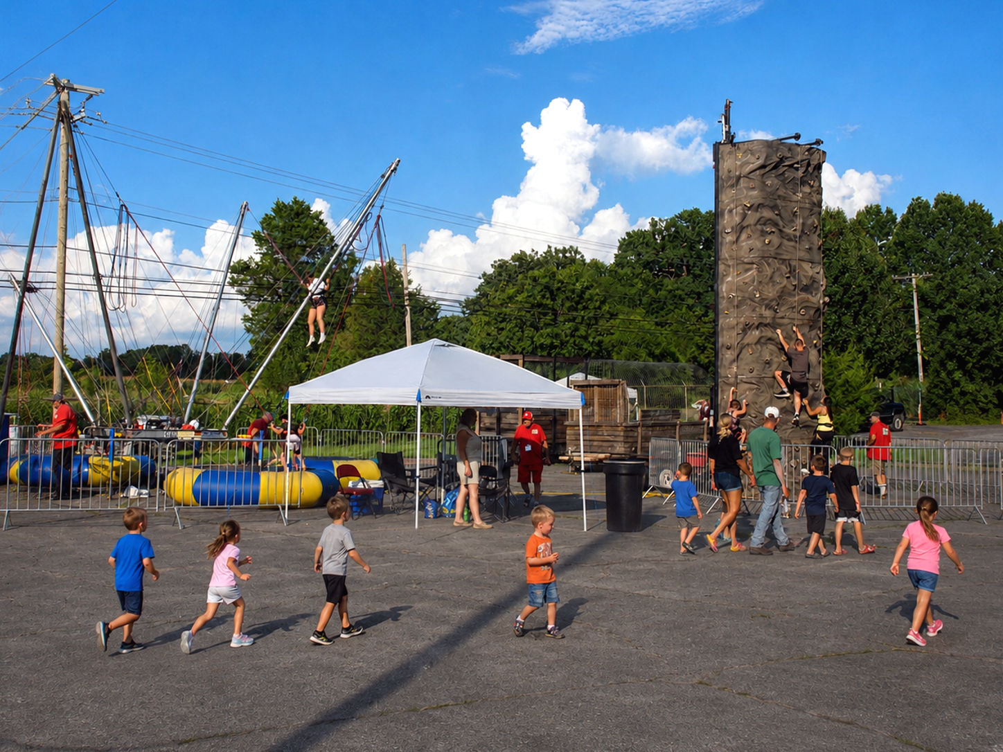 Fairgoers walk among vendors and attractions at the inaugural Sullivan County Fair in Piney Flats, Tenn., in August 2026. The six-day fair, held Aug. 3-8, offered rides, games, inflatables, food vendors and nightly live entertainment. [Photo: S Cobaugh]