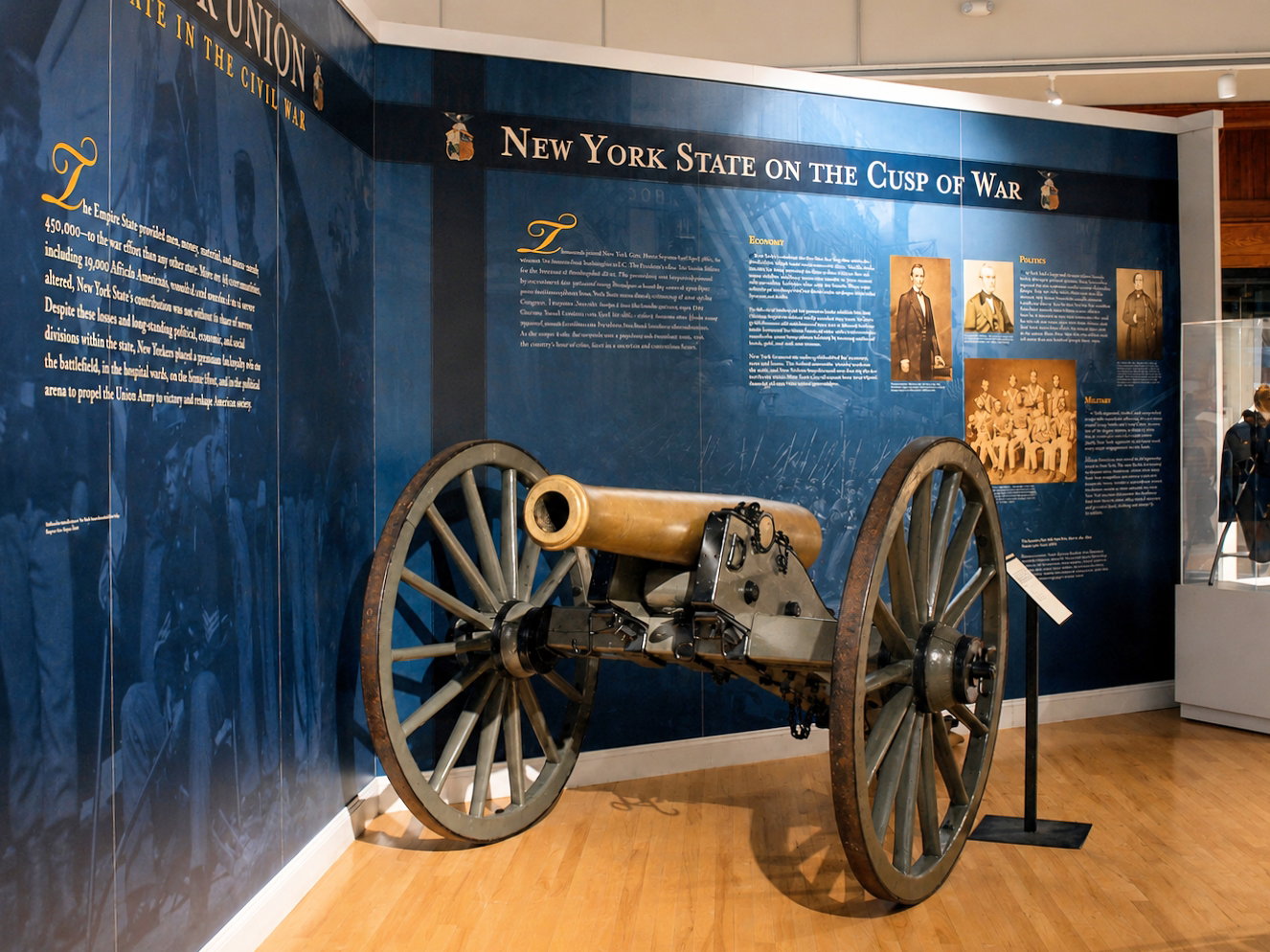 A Civil War-era artillery piece stands before the “New York State on the Cusp of War” display at the New York State Military Museum and Veterans Research Center in Saratoga Springs, N.Y. Civil War history is a particular strength of the museum’s collection, which includes uniforms, weapons, artifacts and what the state says is the nation’s largest collection of Civil War battle flags. [Photo: D Dymond, Aug. 21, 2026]