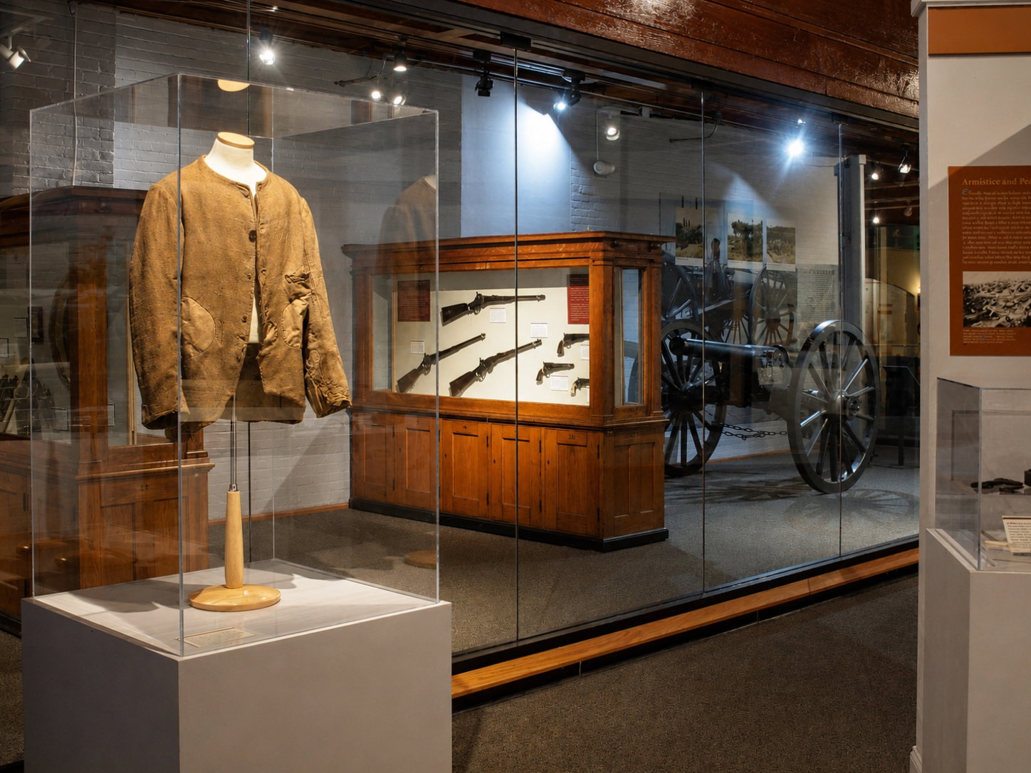 A historic uniform, rifles, handguns and an artillery piece are displayed at the New York State Military Museum and Veterans Research Center in Saratoga Springs, N.Y. The museum preserves military objects and archival material associated specifically with New York and New Yorkers, helping document the evolution of the state’s militia, National Guard and wartime service. [Photo: D Dymond, Aug. 21, 2026]