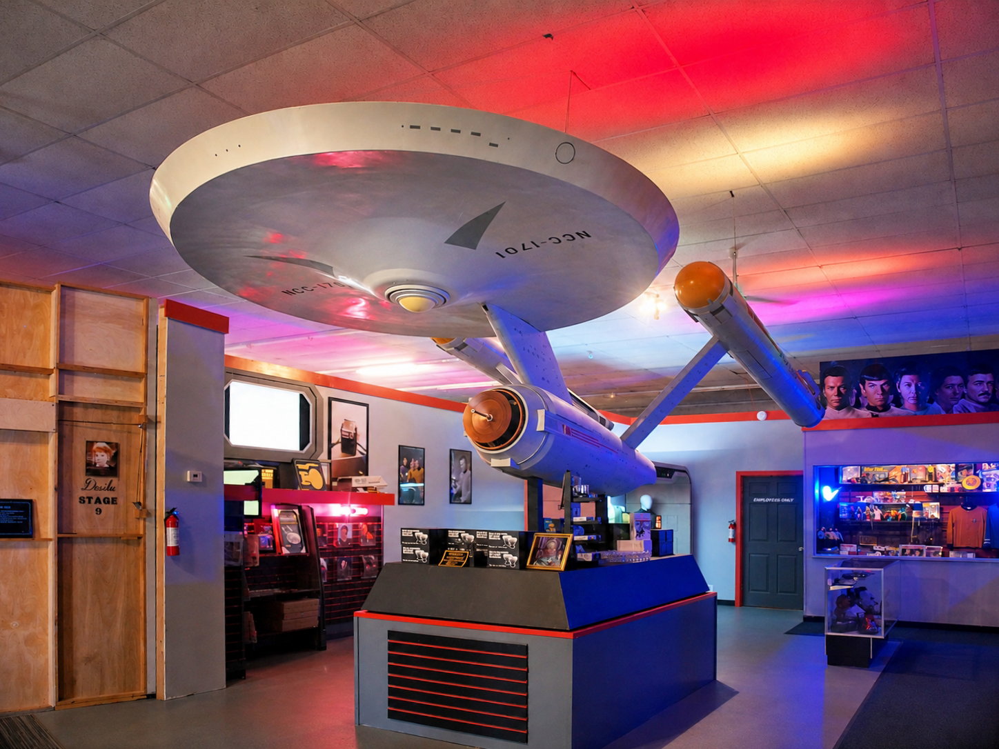 A giant model of Star Trek's starship, the U.S.S. Enterprise, hangs above exhibits inside the lobby of the Star Trek Original Series Set Tour in Ticonderoga, N.Y. Fans can explore recreated spaces built from the original blueprints. [Photo: S Cobaugh, Aug. 21, 2026]