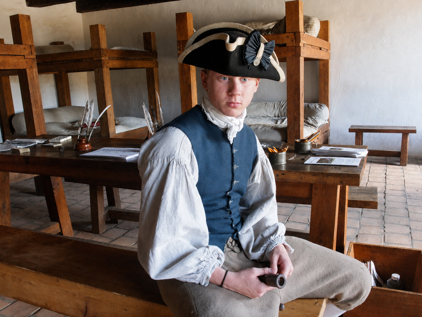 America 250: A costumed interpreter portrays 18th-century military life inside the barracks at Fort Ticonderoga in Ticonderoga, N.Y. The fort’s living-history program uses demonstrations, historic trades and soldiers’ life programs to interpret the experiences of the thousands of troops who occupied the strategic Lake Champlain stronghold. [Photo: S Cobaugh, Aug. 22, 2026]