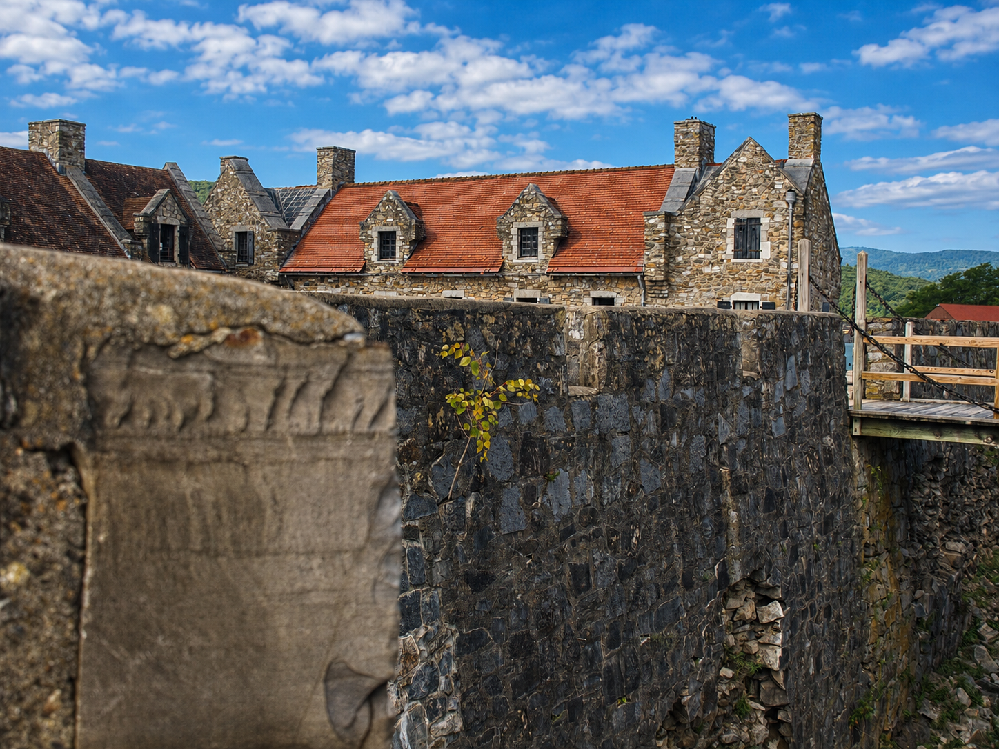 America 250: Restored stone buildings rise behind the defensive walls of Fort Ticonderoga in Ticonderoga, N.Y. After merchant William Ferris Pell acquired the deteriorating fort property in 1820, his descendants began reconstructing much of the historic complex in 1909, the same year the Fort Ticonderoga Museum opened to the public. [Photo: D Dymond, Aug. 22, 2026]
