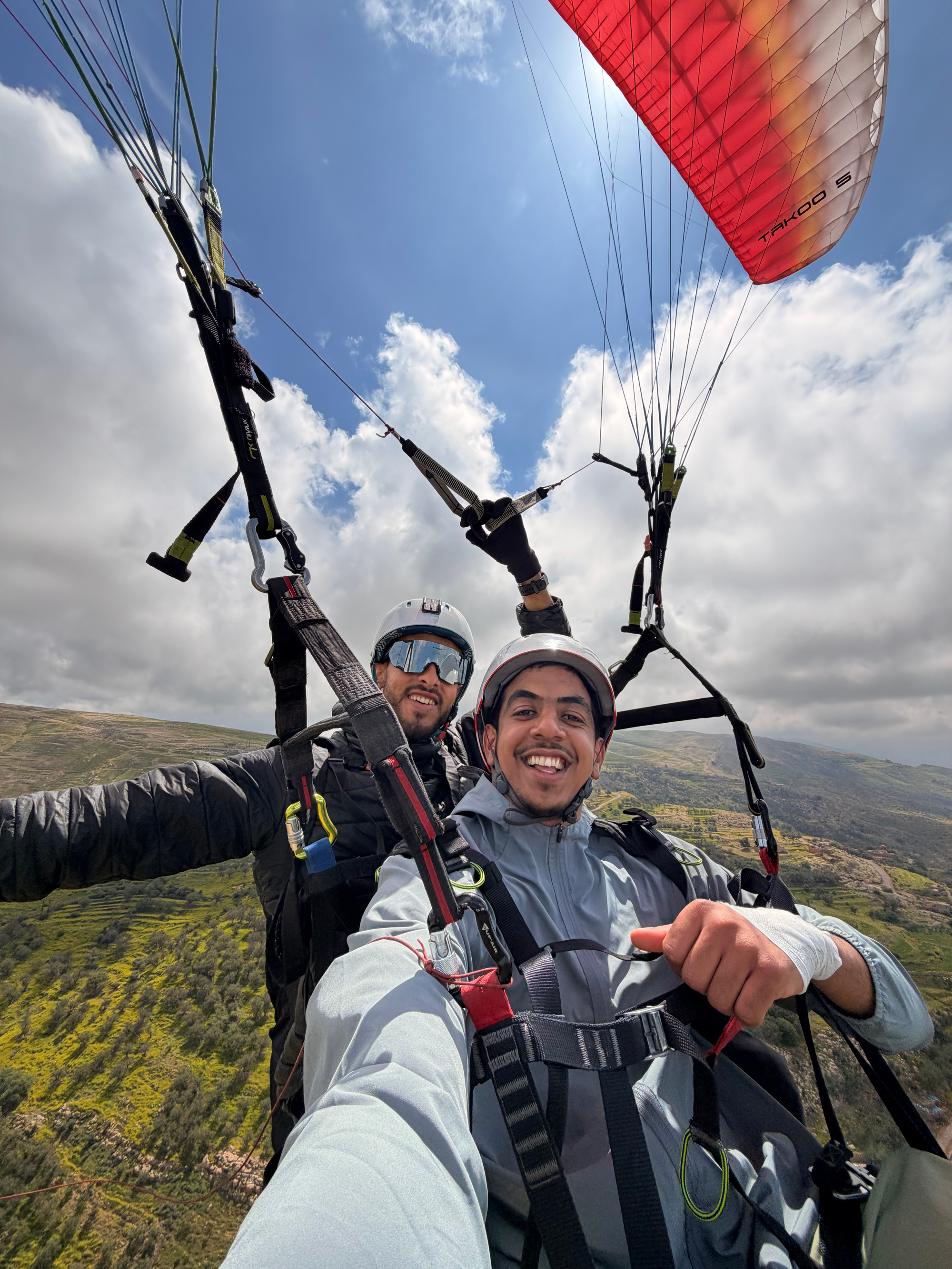 Happy smiling customer enjoying the tandem paragliding experience
