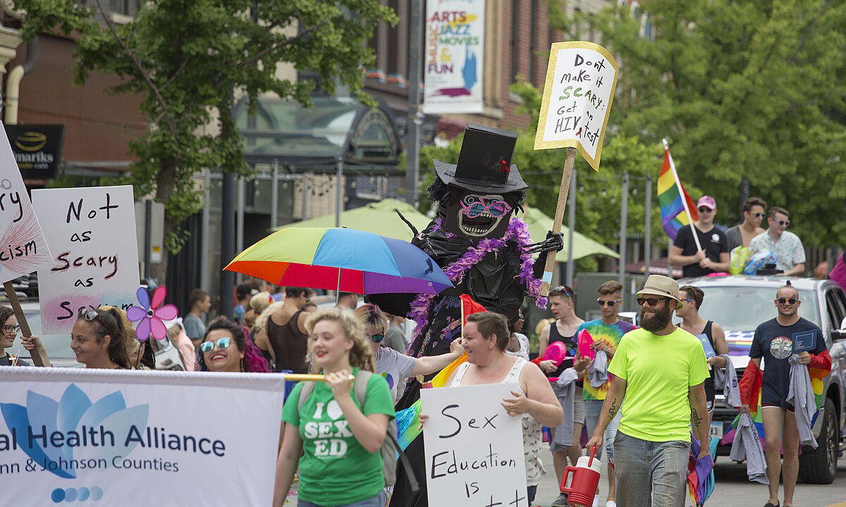 Photograph of a crowd at Iowa City pride with a participant dressed as the Babadook monster.