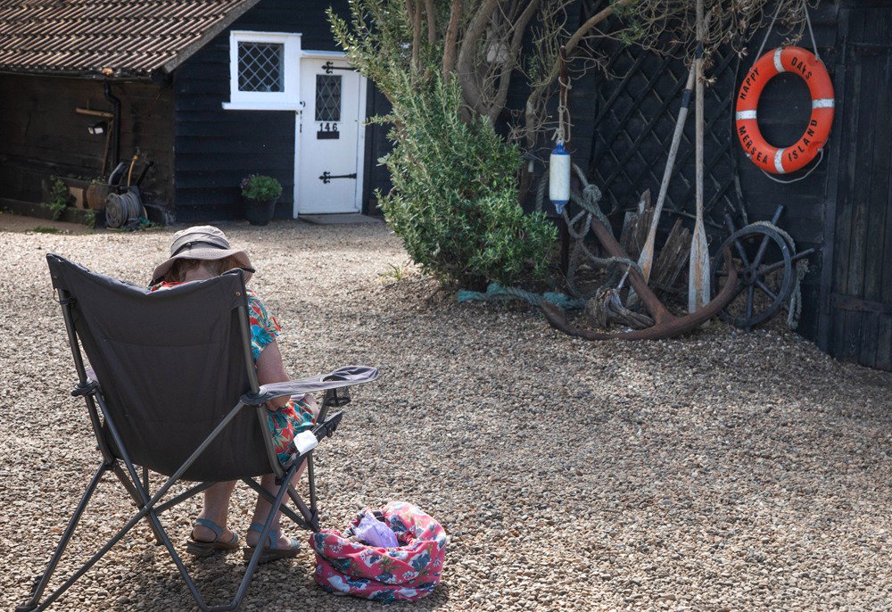 Mary Woodcock. Mary sketching beautiful cottages along Coast Road, West Mersea. Photo taken by Chrissie Westgate.