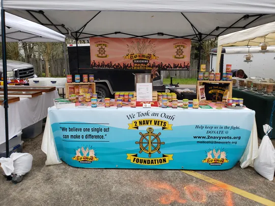 2 Navy Vets Foundation set up tent with their homemade seasoning 