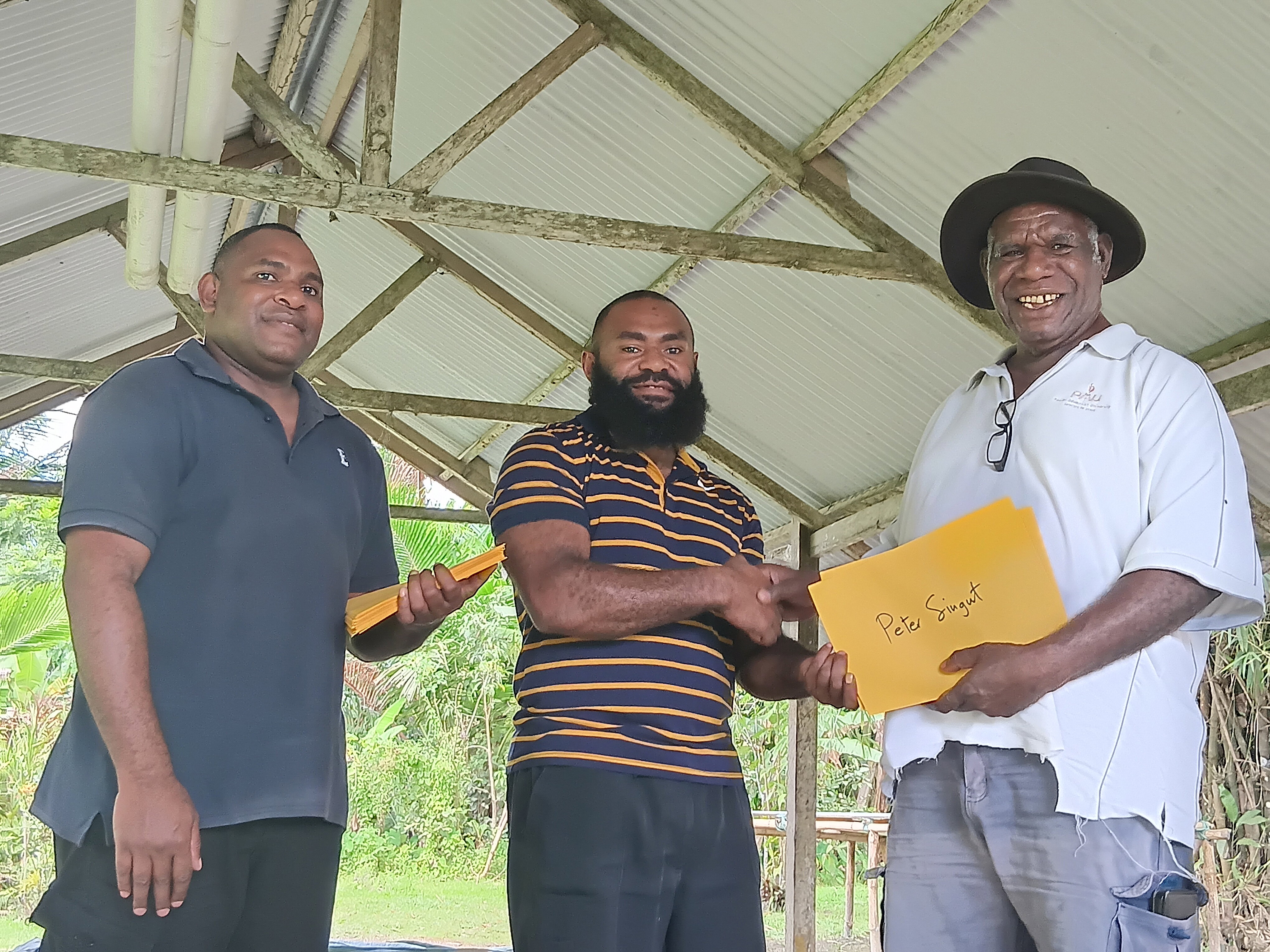 Presentation of certificate to Mr. peter Singut, one of the prominent entrepreneur out of the many male adults that attended the training.