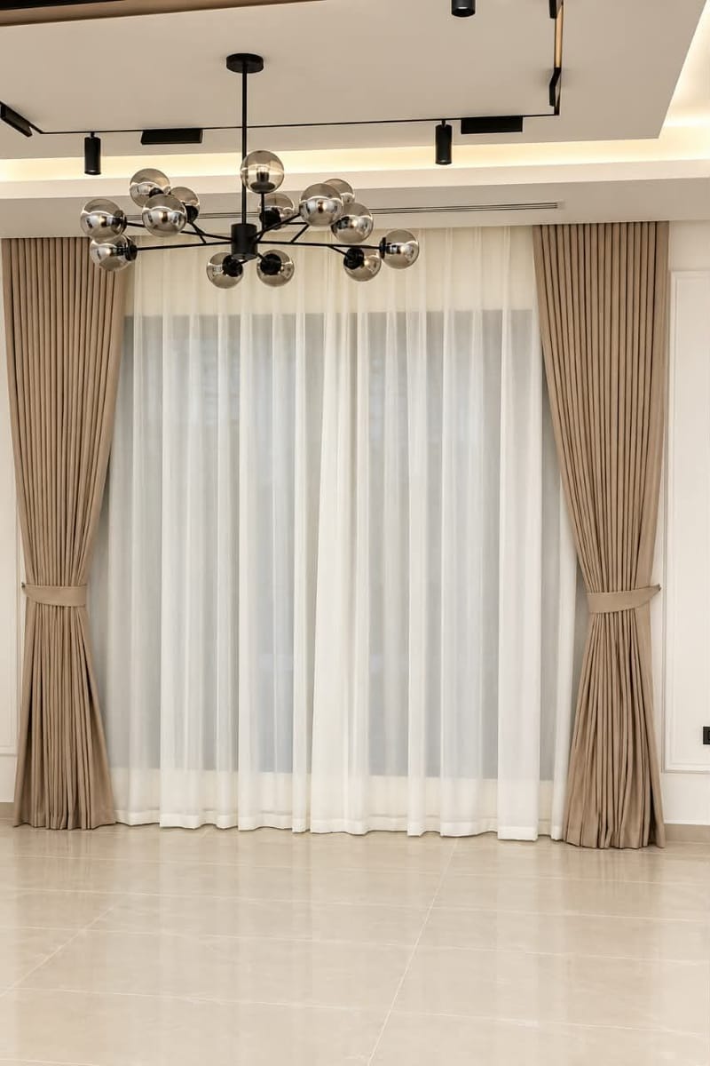 Modern Elegance : Layered Taupe Drapes with sheer Curtains