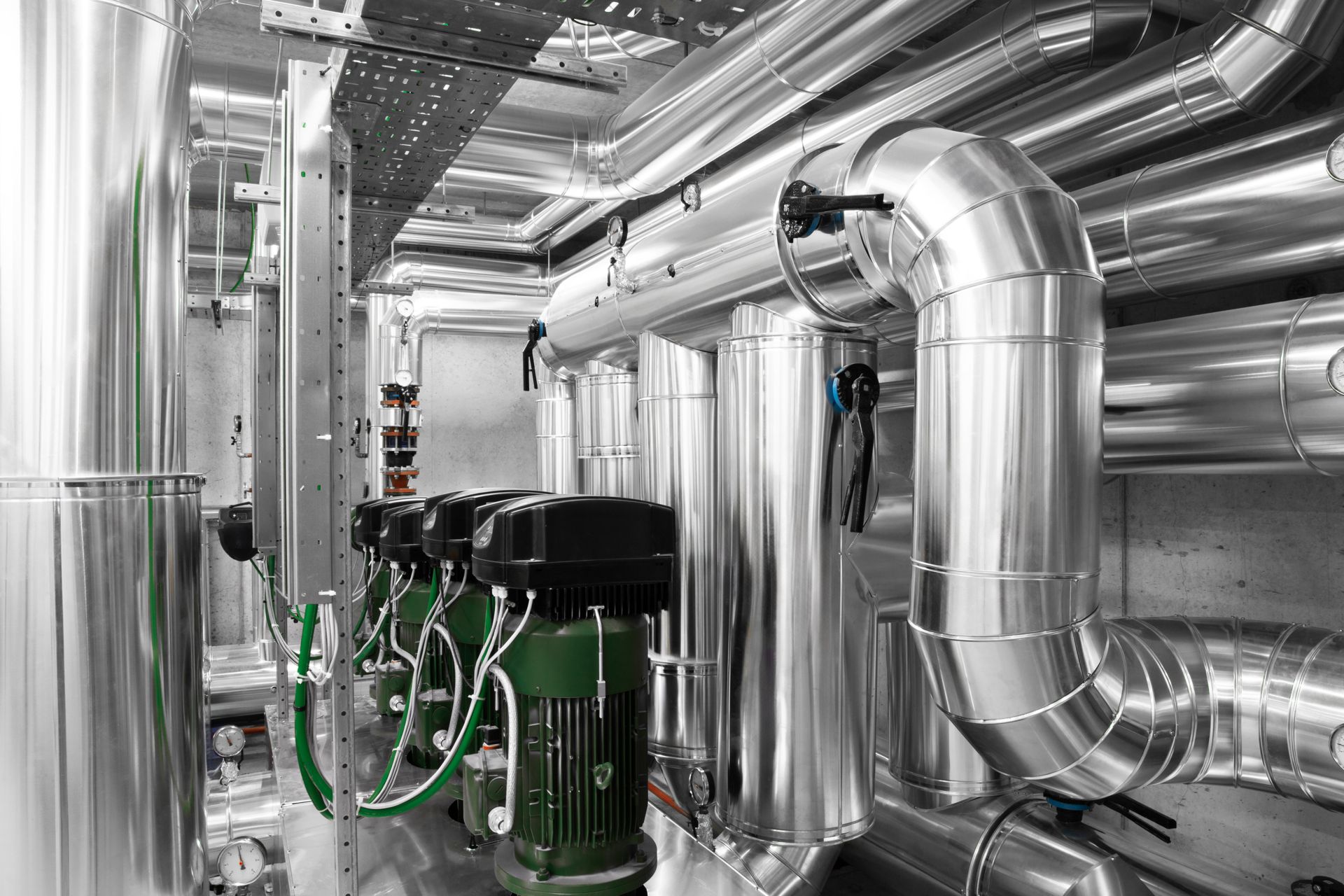 Commercial plant room with insulated heating pipework and circulating pumps