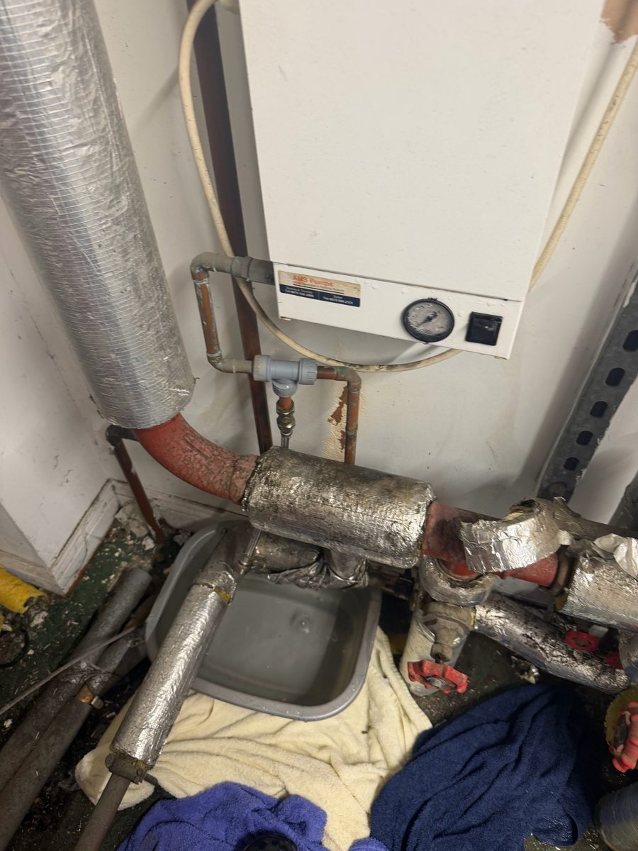 Flooded plant room pipework at a Farnworth care home