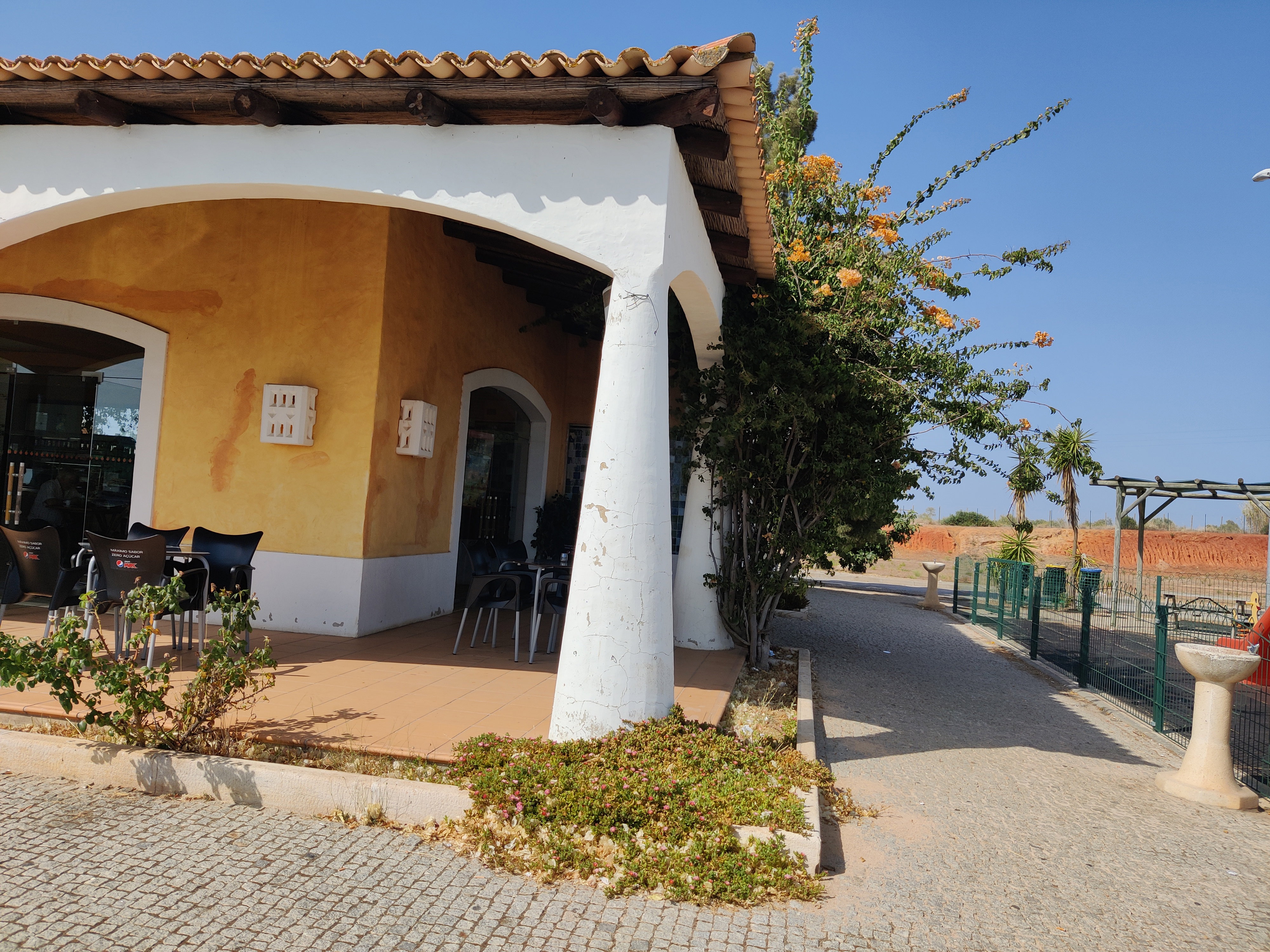 Algarve: A traditional whitewashed and terracotta villa with bougainvillea in the sun-baked Algarve, southern Portugal.