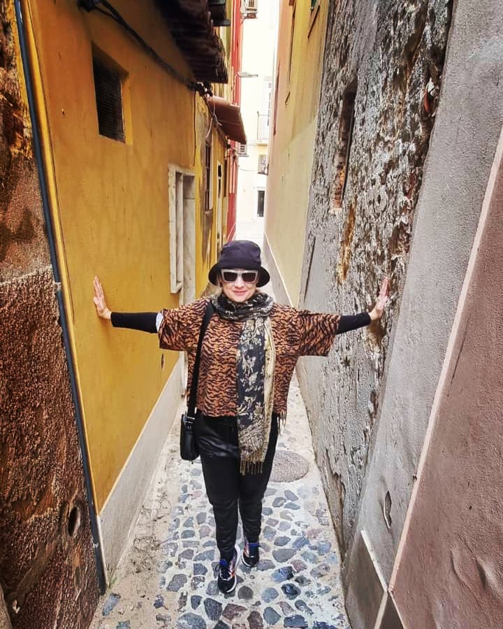 Narrow cobbled pedestrian street between colourful buildings in Setubal Portugal