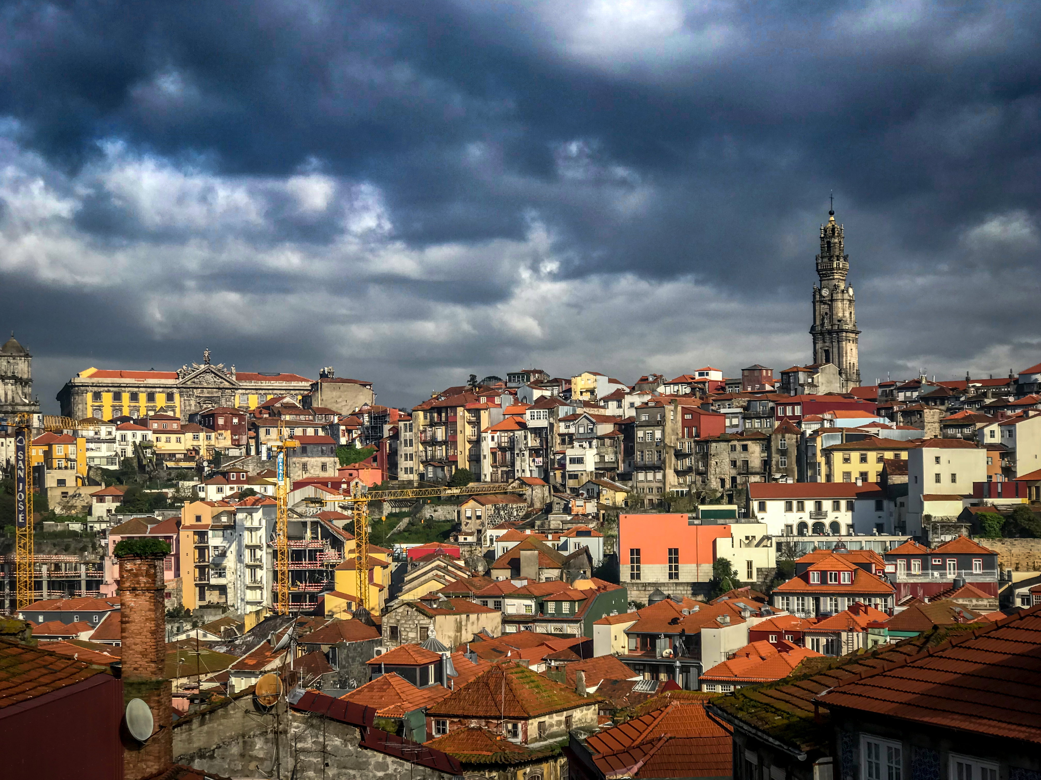Porto: Storm clouds gathering over the rooftops of Porto, northern Portugal, with the Clérigos tower above the old city.