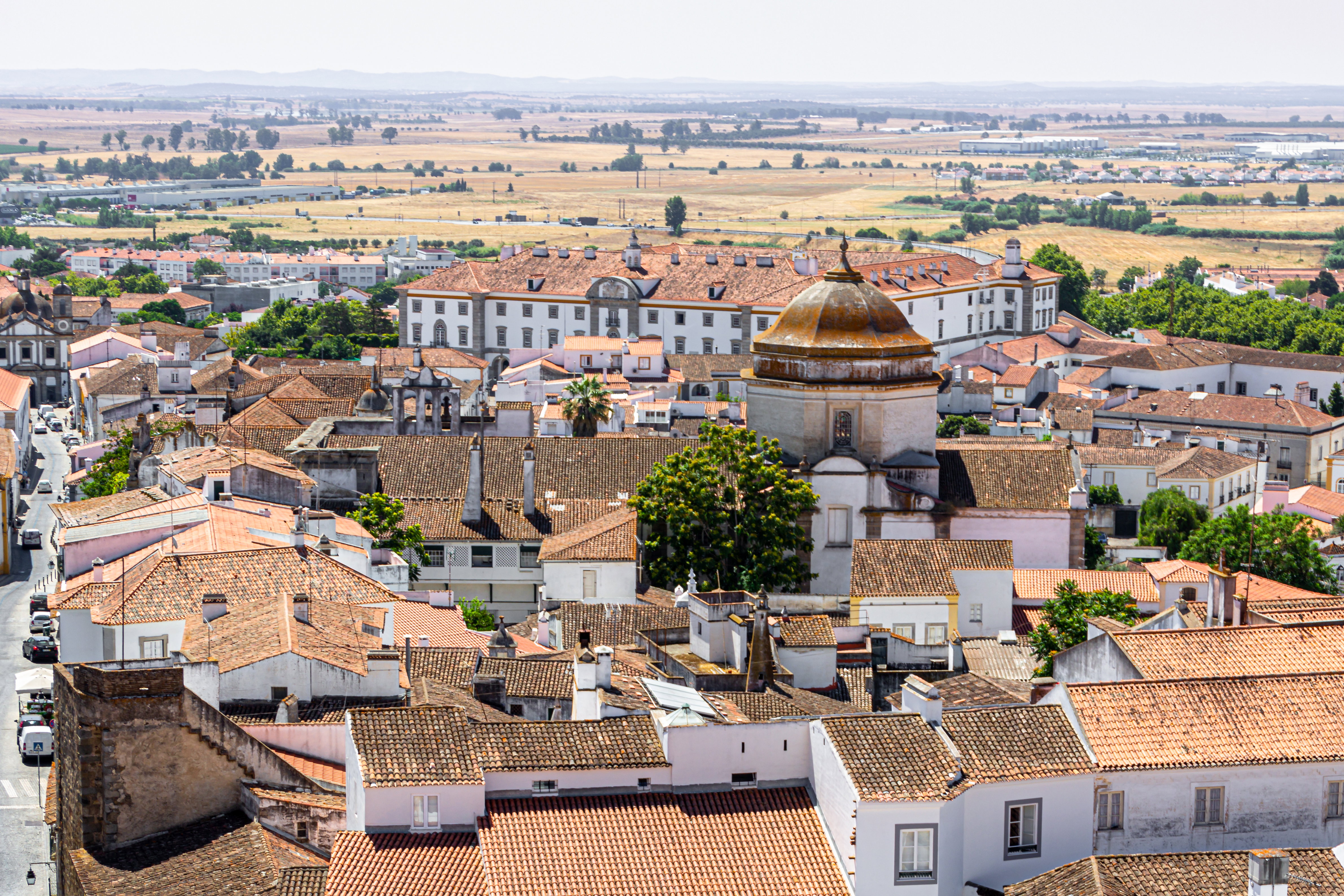 Alentejo: Terracotta rooftops of Évora giving way to the wide open plains of Portugal's Alentejo.