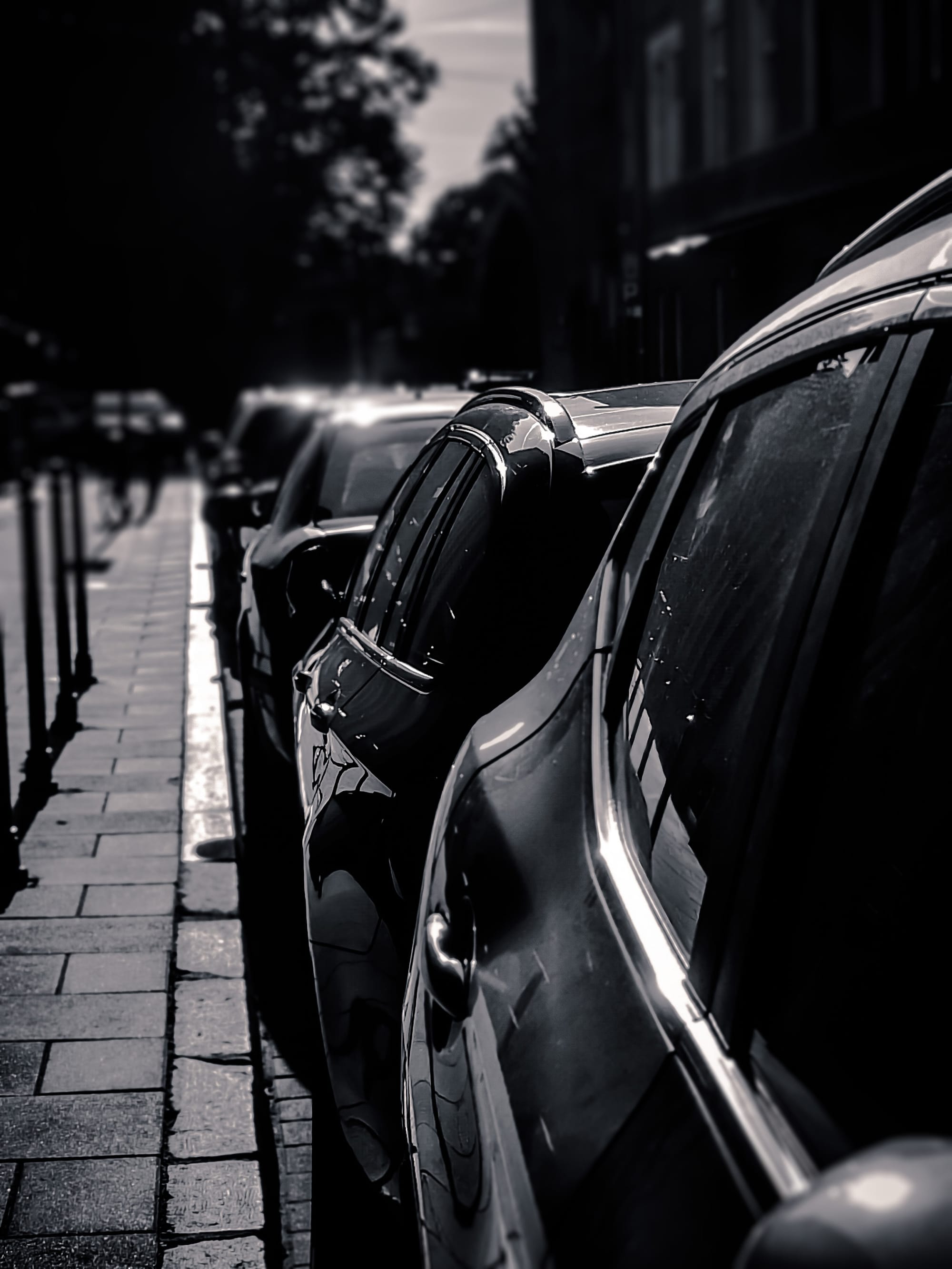Premium black rental car parked on a city street