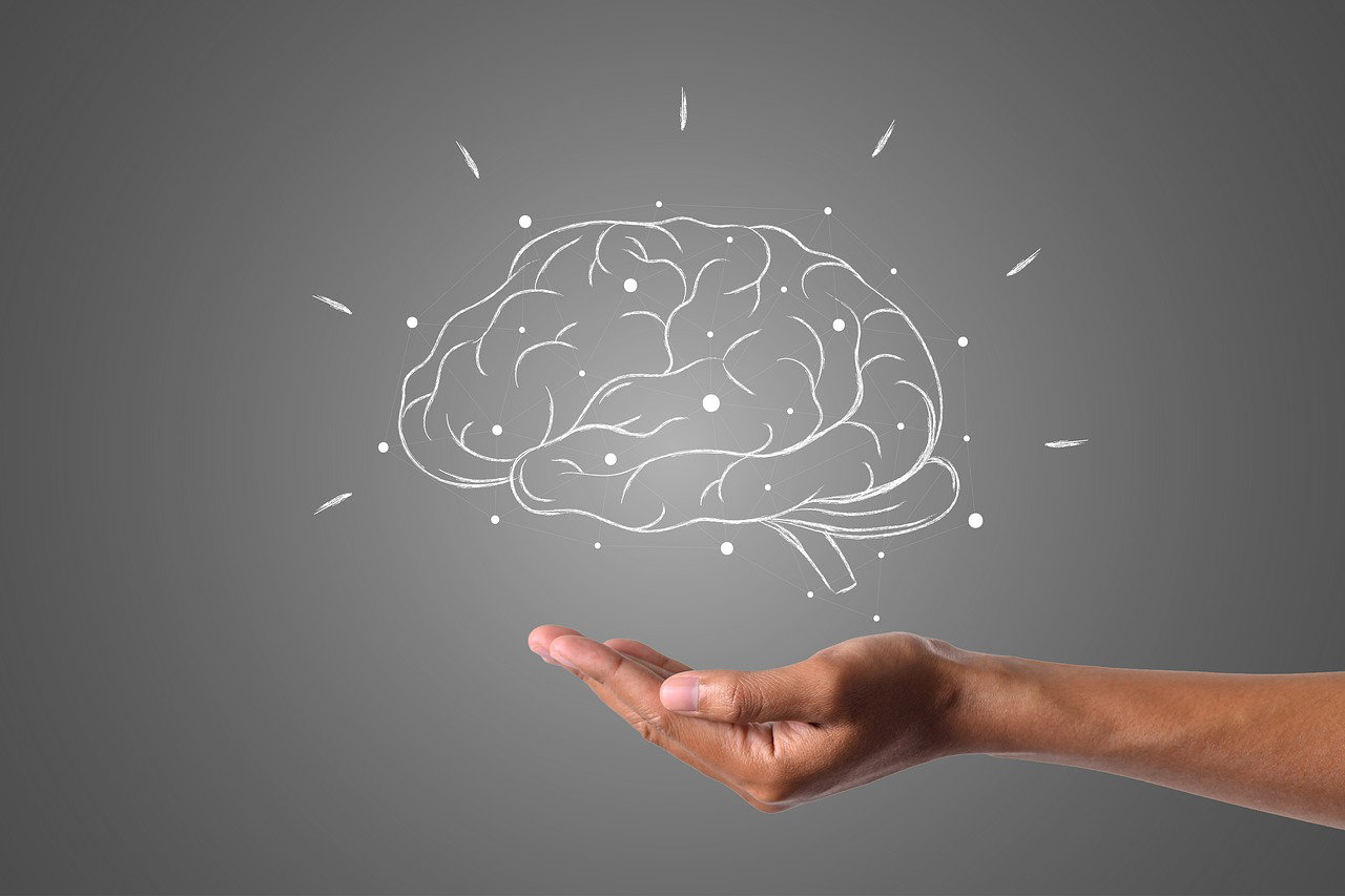 Brain icon above hand representing mental focus and brain function