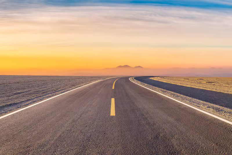 Moody desert road at sunset