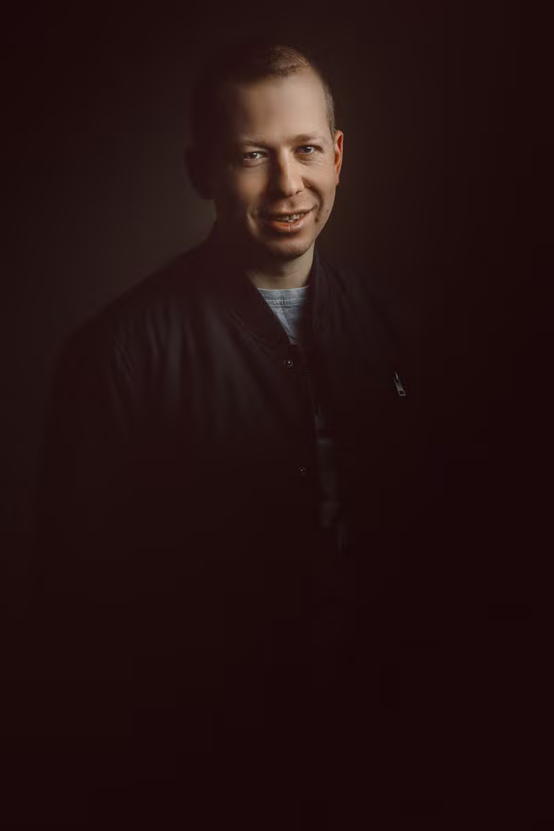 Modern founder portrait on a dark background