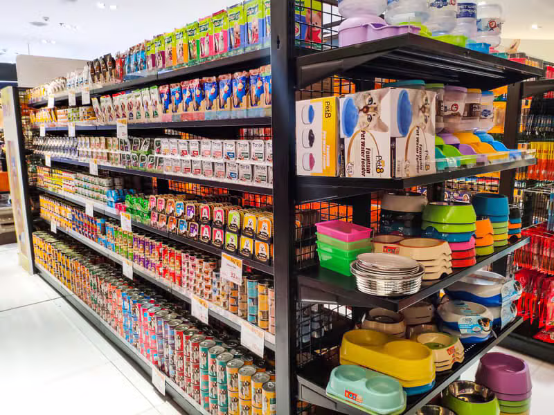 Premium pet supplies arranged on warm store shelves