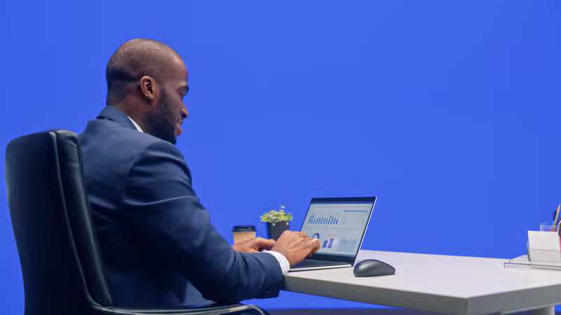 Person watching a financial presentation on a laptop