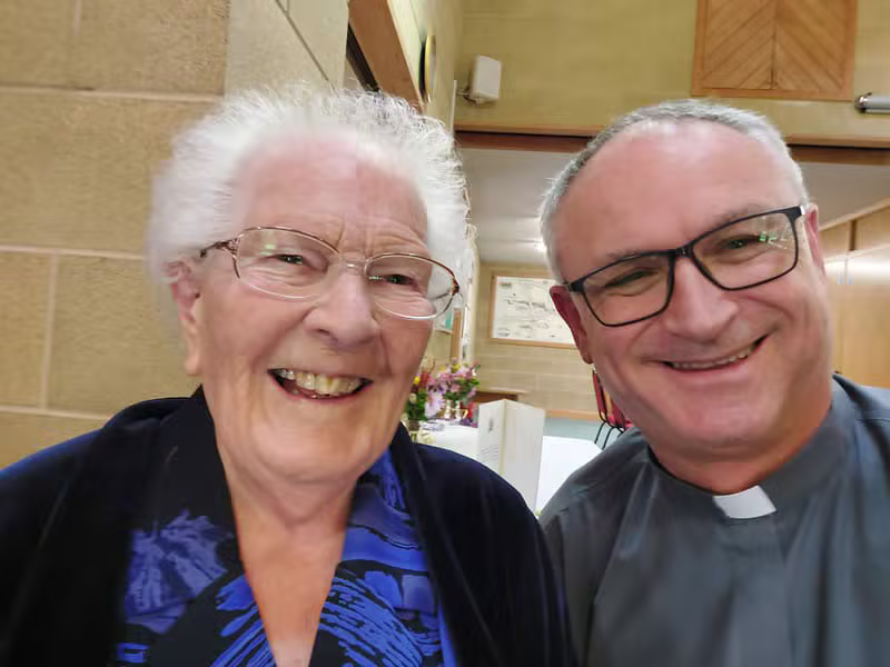 Minister and congregation member smiling together