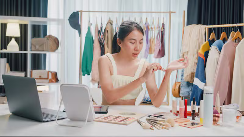 Beauty creator applying makeup with a ring light