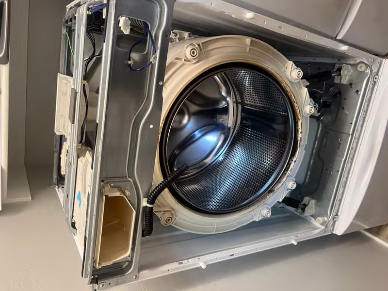 Detailed view of professional appliance repair work in progress
