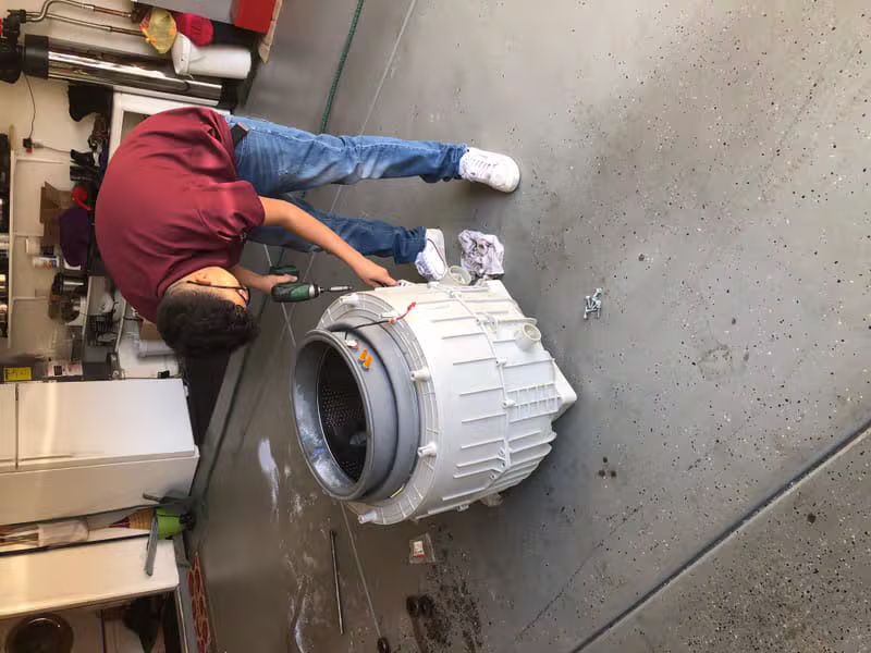 Professional technician replacing a washer bearing