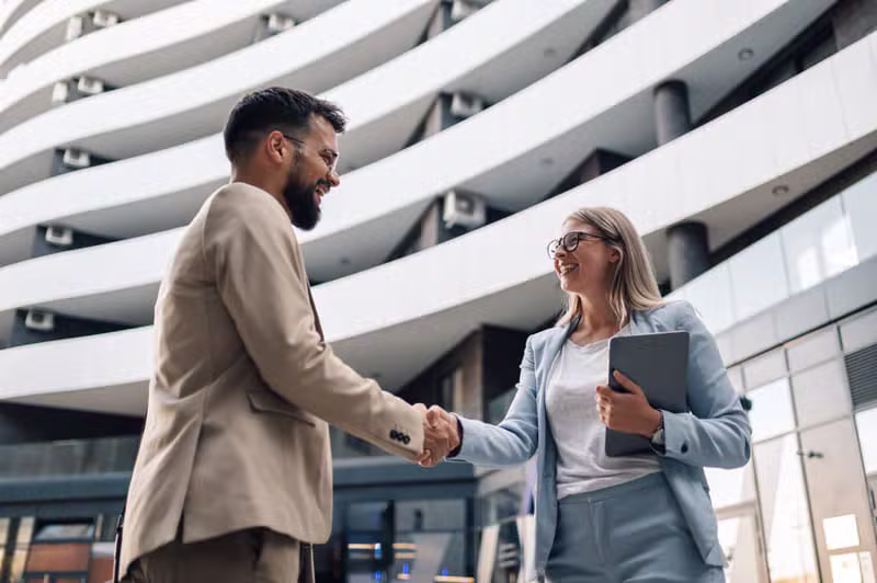 Business partners shaking hands demonstrating corporate trust