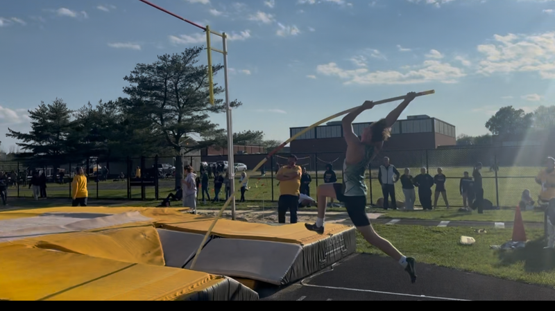 Pole vaulter clearing the bar
