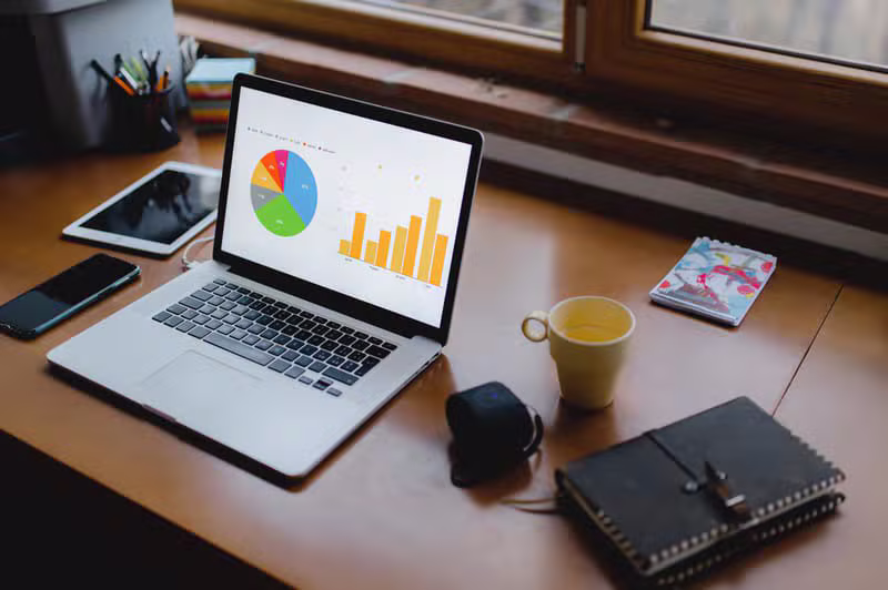 Modern workspace with analytics dashboards and hardcover books